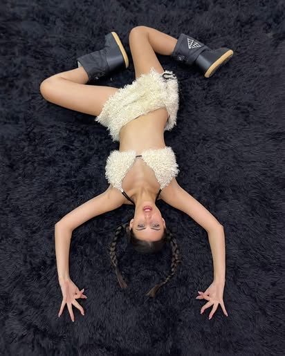 Campaign shot with arms open on black fur